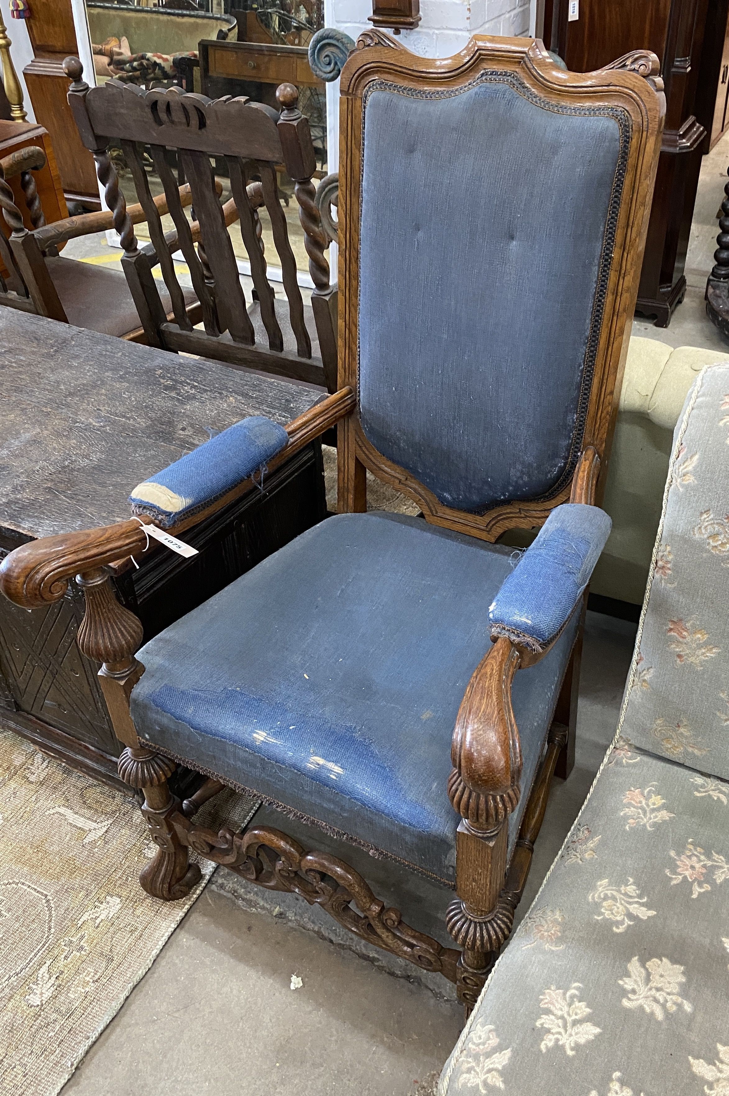 A Carolean style oak upholstered open armchair, width 65cm, depth 55cm, height 118cm